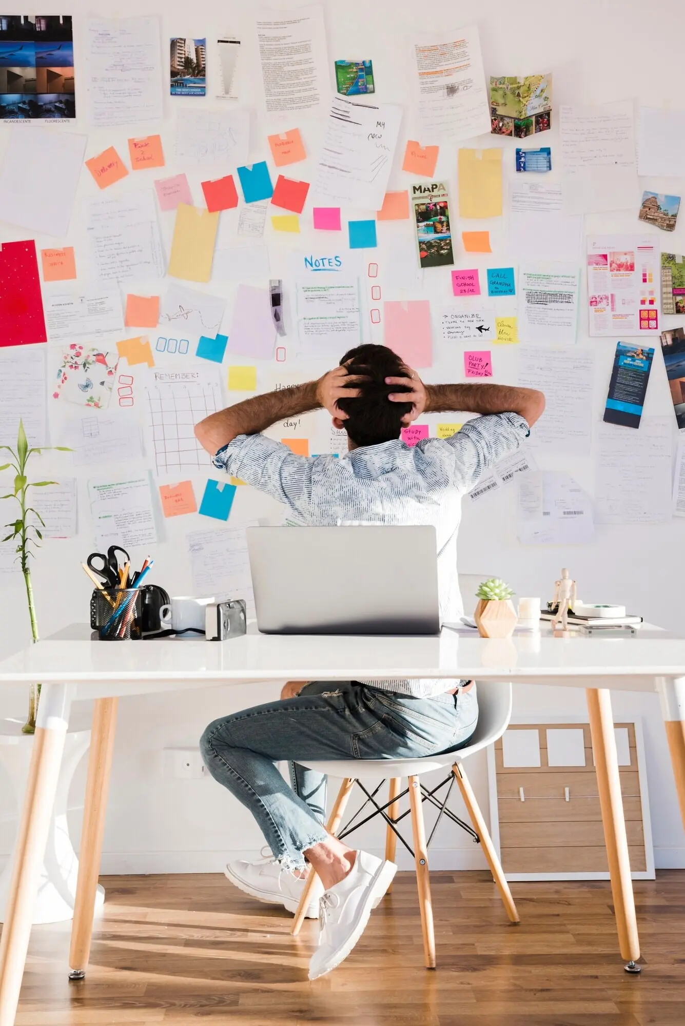 Ganzkörperaufnahme eines Mannes, der auf einem Stuhl sitzt.